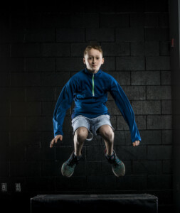Middle school aged boy jumping